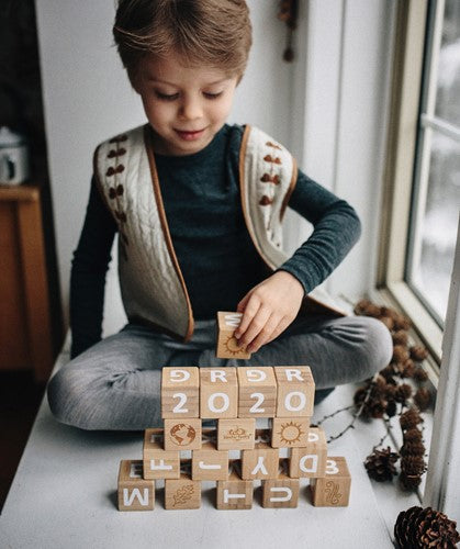 Child playing with ABC and number blocks